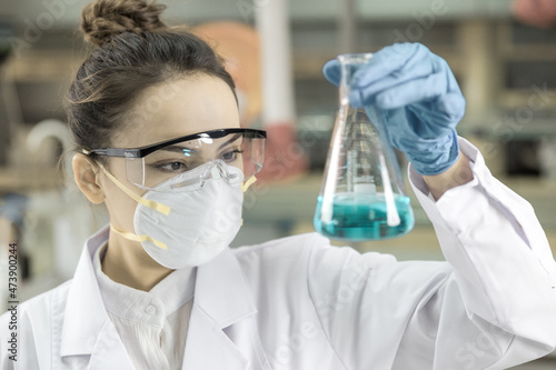 Female scientist looking at the scientific sample in the CDC laboratory.	