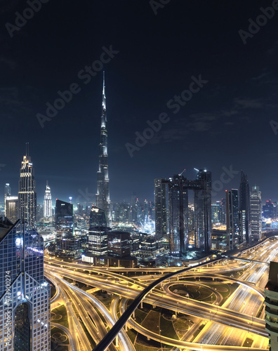 Modern city skyline and cityscape at night in Dubai UAE.