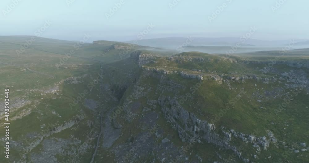 Flying over limestone pavement and misty valley. Flying over limestone pavement and misty valley.