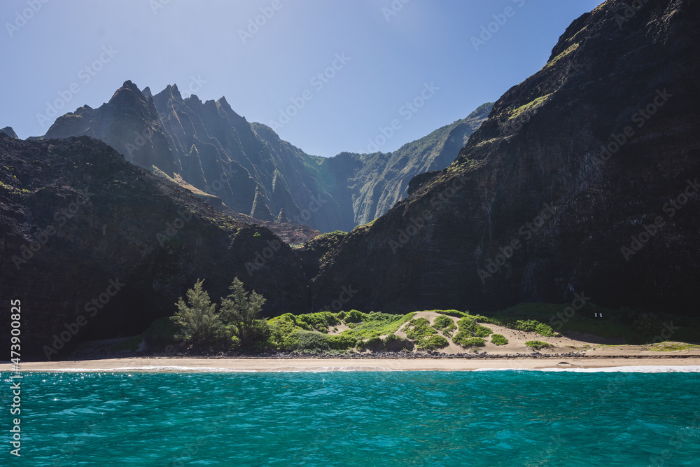 Beautiful mountain forms in kauai, hawaii with clear skies and water view