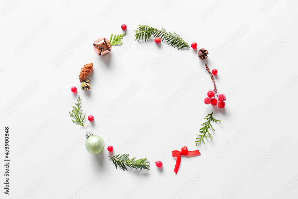 Beautiful wreath made of fir branches and Christmas decor on light background Beautiful wreath made of fir branches and Christmas decor on light background