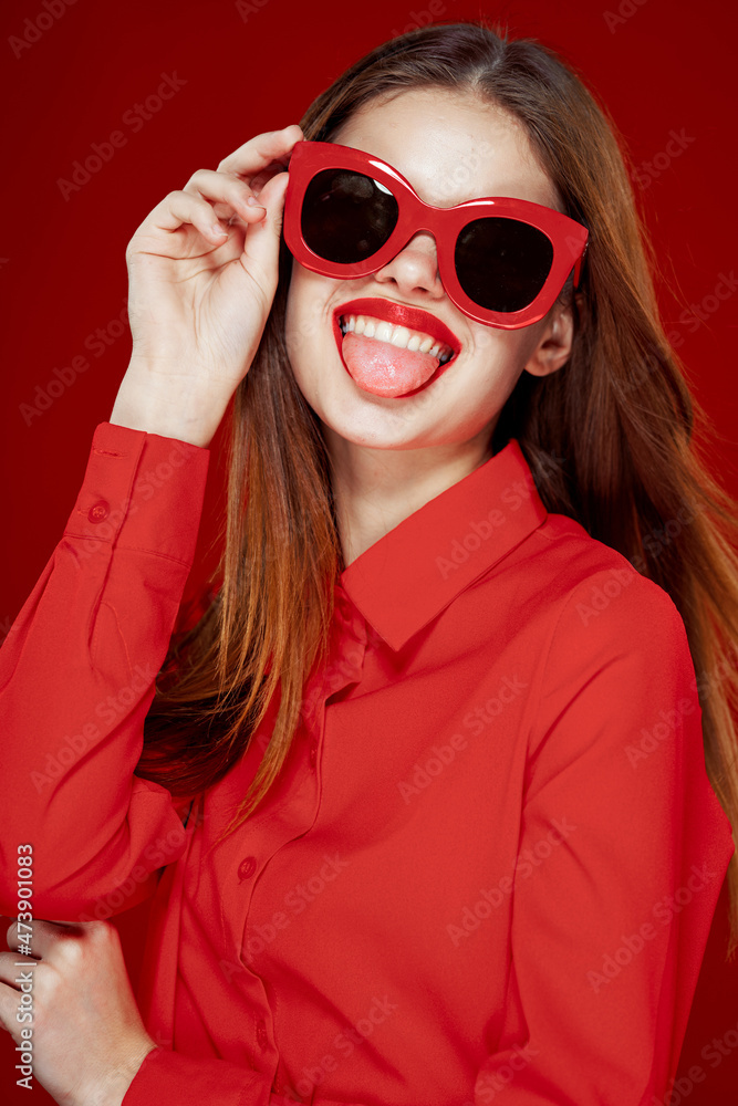 cheerful woman in a red shirt sunglasses Glamor close-up cheerful woman in a red shirt sunglasses Glamor close-up