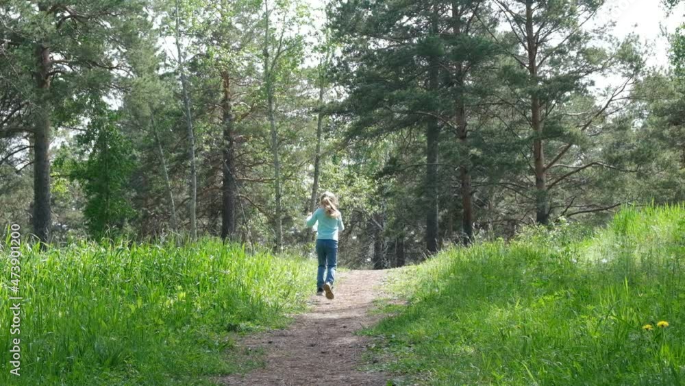 Child girl running uphill along path in Forest, Active outdoor games. Slow motion Child girl running uphill along path in Forest, Active outdoor games. Slow motion