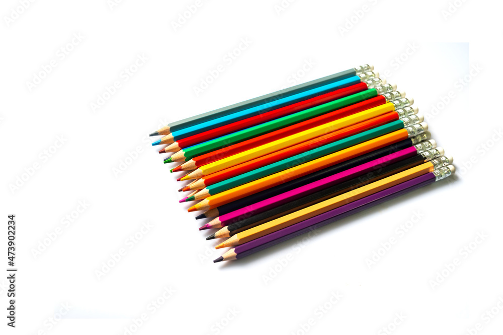 Color pencils on white background.Set of wooden color pencils arranged in bulk with copy space.Photo select focus. Color pencils on white background.Set of wooden color pencils arranged in bulk with copy space.Photo select focus.