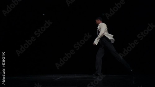 Wallpaper Mural Solo performance fragment,ballroom dancer on stage in white shirt,naked tanned torso.Movement across stage,search for woman partner,making steps,jupms,lunges and chaines tours,hip rotation.Long shot. Torontodigital.ca