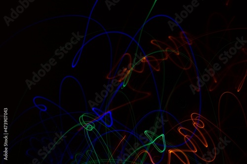 Multicolored neon lights on black background