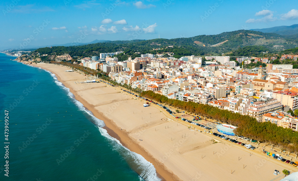 Birds eye view of Calella, Spain. Residential building along Mediterranean sea coast and beach visible from above.