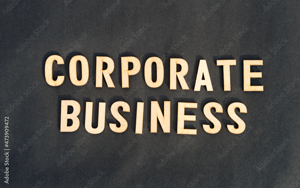 Obraz premium Corporate word and business concept. Wooden cubes words Corporate Business isolated on black background. Business Finance Industry concept.