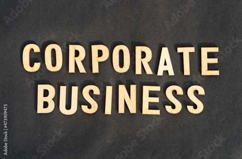 Corporate word and business concept. Wooden cubes words Corporate Business isolated on black background. Business Finance Industry concept.