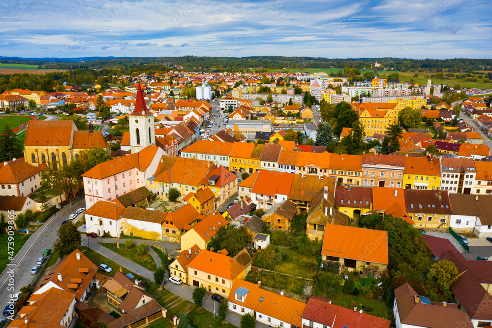 Aerial view of historical centre of Blatna in autumn day overlooking bell tower of gothic church of Assumption of Mary, Czech Republic