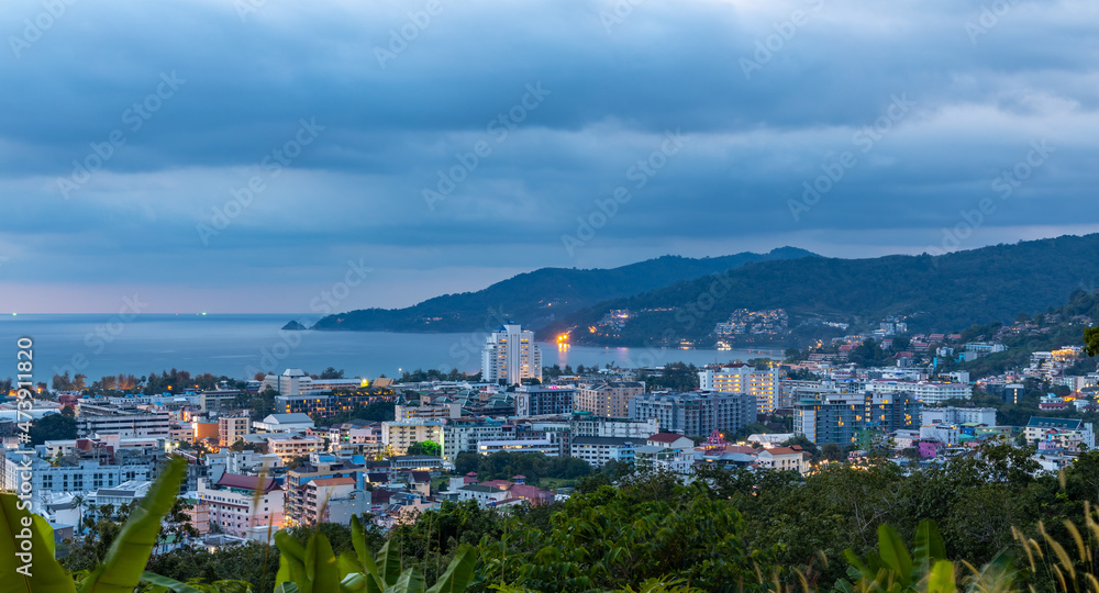 night sunset view of Patong and patong beach with the buildings and high-rise hotels and resorts in the background Kathu phuket Thailand 