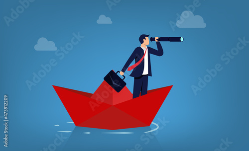 Business management and direction. Businessman holding telescope on paper boat symbol.