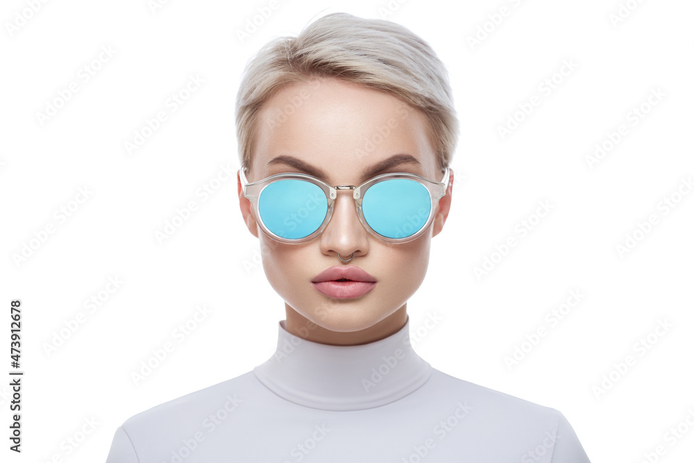 Fashion portrait of a beautiful girl with a short haircut in blue sunglasses. White background. Fashion portrait of a beautiful girl with a short haircut in blue sunglasses. White background.
