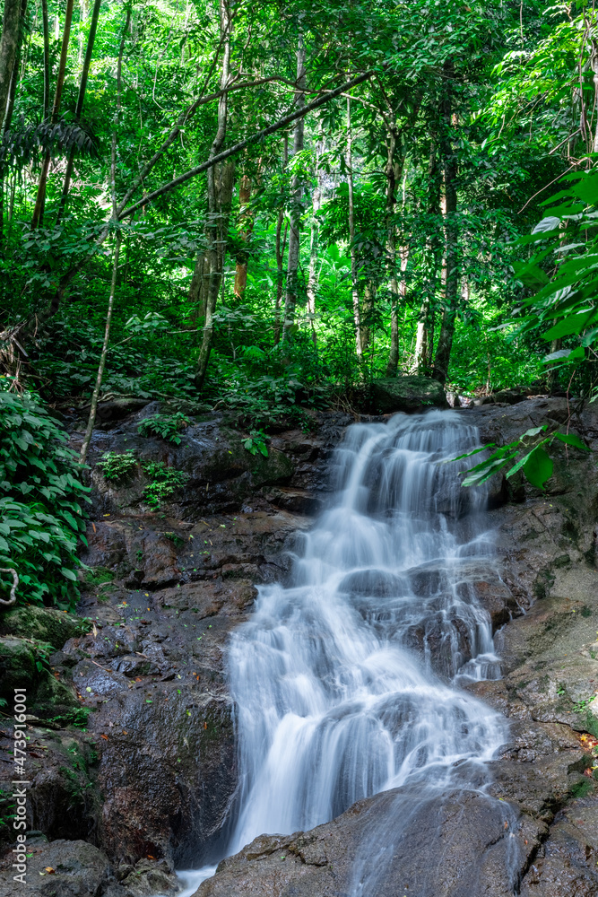 Fototapeta premium Kathu waterfall water gently flowing down the rocks Patong Phuket Thailand Asia