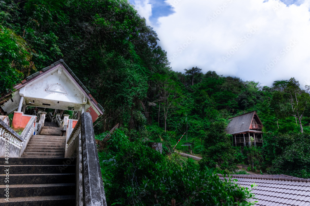 Timber hut in Kathu forest near water fall district mountains surrounded by lush green trees Phuket Thailand Timber hut in Kathu forest near water fall district mountains surrounded by lush green trees Phuket Thailand