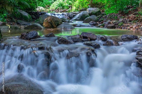 Fototapeta Naklejka Na Ścianę i Meble -  Kathu waterfall water gently flowing down the rocks Patong Phuket Thailand Asia