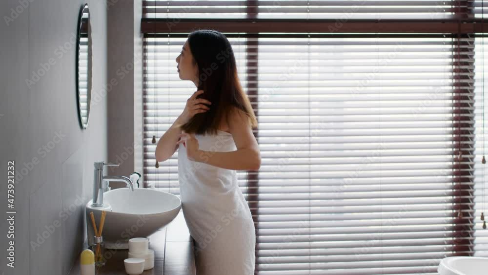 Asian Woman Wrapped In Towel Touching Her Thick Beautiful Hair Near Mirror Asian Woman Wrapped In Towel Touching Her Thick Beautiful Hair Near Mirror