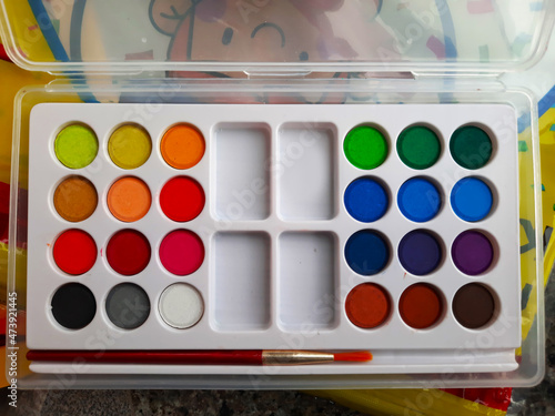 painting and art purpose dry watercolor cakes set with brush top view