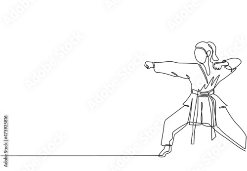 Continuous one line drawing young confident karateka woman in kimono practicing karate punch combat at dojo gym center. Mastering martial art sport concept. Single line draw design vector illustration