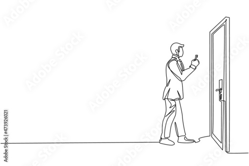 Continuous one line drawing businessman lifts key in front of door. Man holding key to open office room door. Starting morning with spirit to work. Single line draw design vector graphic illustration