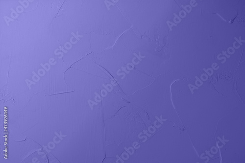 Textured decorative plaster in purple colors with gradient toned. Background for your ideas. Color of the Year 2022