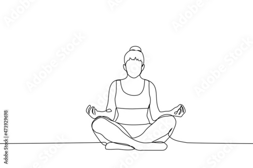 woman in sports top and leggings sits in lotus position with bun of hair on her head - one line drawing vector. alone exercise concept, meditation process