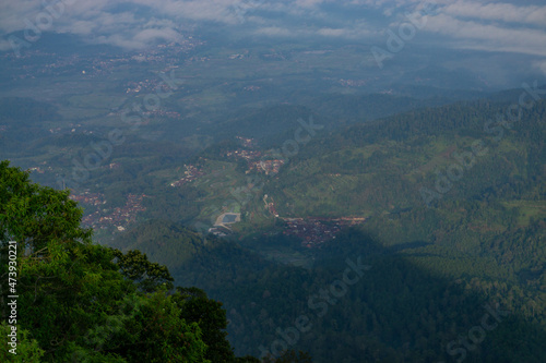 Landscape photo of mountain taken from highland with tree and bushes foreground . this is the view from top of Mount Telomoyo