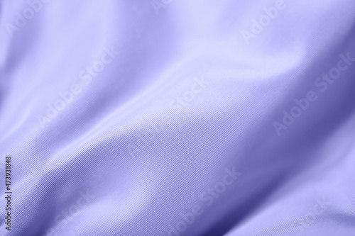 color of year 2022 - Very Peri. minimal lilac background with folds and waves on fabric. purple. photo