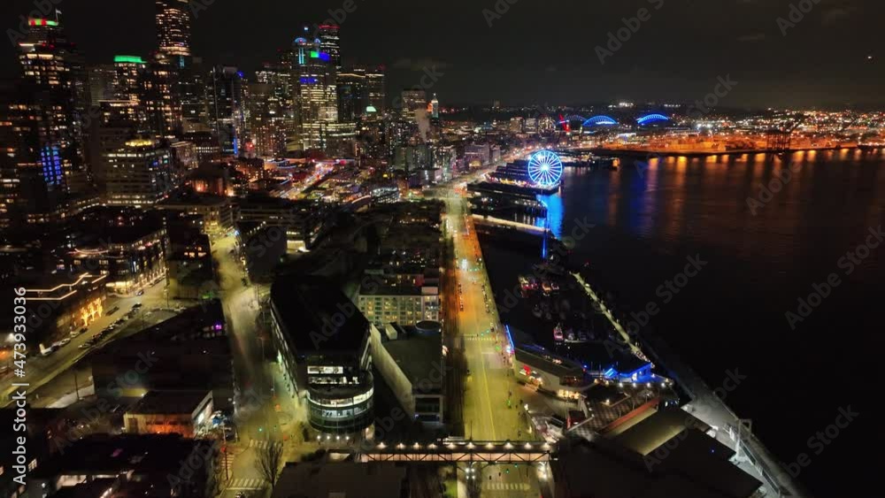 Cinematic 4K aerial drone night dolly shot of Belltown Alaskan Way waterfront Harbor marina Pike Place, Seattle Aquarium, Elliott Bay, Lumen Field, Great Wheel downtown Seattle Washington Cinematic 4K aerial drone night dolly shot of Belltown Alaskan Way waterfront Harbor marina Pike Place, Seattle Aquarium, Elliott Bay, Lumen Field, Great Wheel downtown Seattle Washington