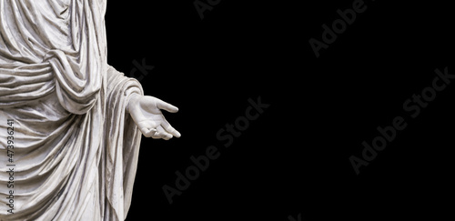Hand holding antique statue on blank black background. Roman classical sculpture in marble with outstretched hand. Knowledge, education, training, charity concept.