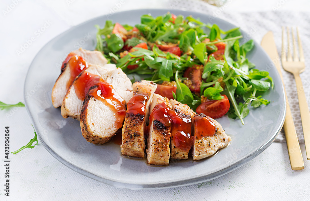 Roasted chicken fillet with salad fresh tomatoes and arugula. Roasted chicken fillet with salad fresh tomatoes and arugula.