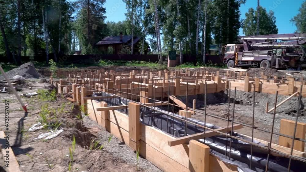 Pouring concrete. Pouring a concrete foundation on a construction site. Construction of a cottage. Pouring concrete. Pouring a concrete foundation on a construction site. Construction of a cottage.