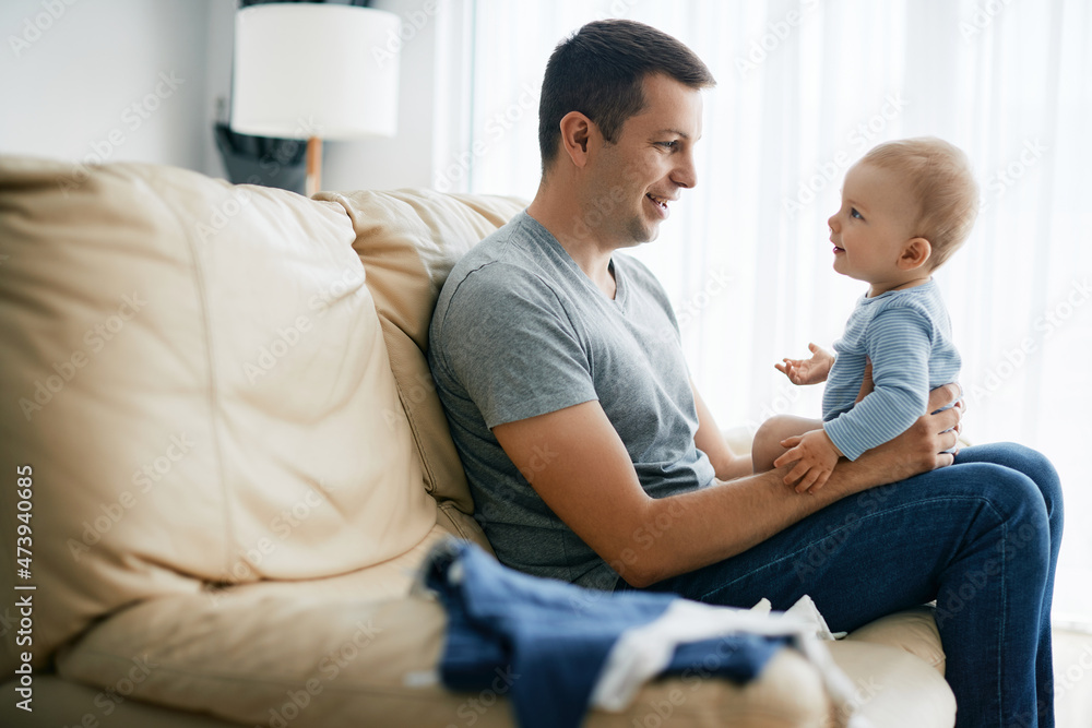 Happy father and son bonding while spending time together at home. Happy father and son bonding while spending time together at home.