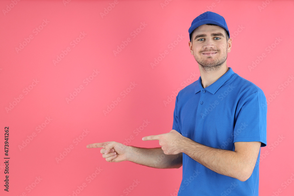 Delivery man in cap and t-shirt on pink background Delivery man in cap and t-shirt on pink background