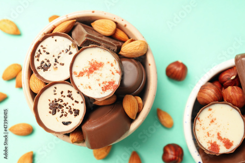 Concept of sweets with chocolate candies on mint background
