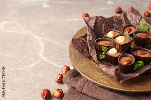 Concept of sweets with chocolate candies on textured background