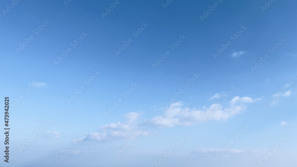 Clear blue sky background with tiny clouds.
