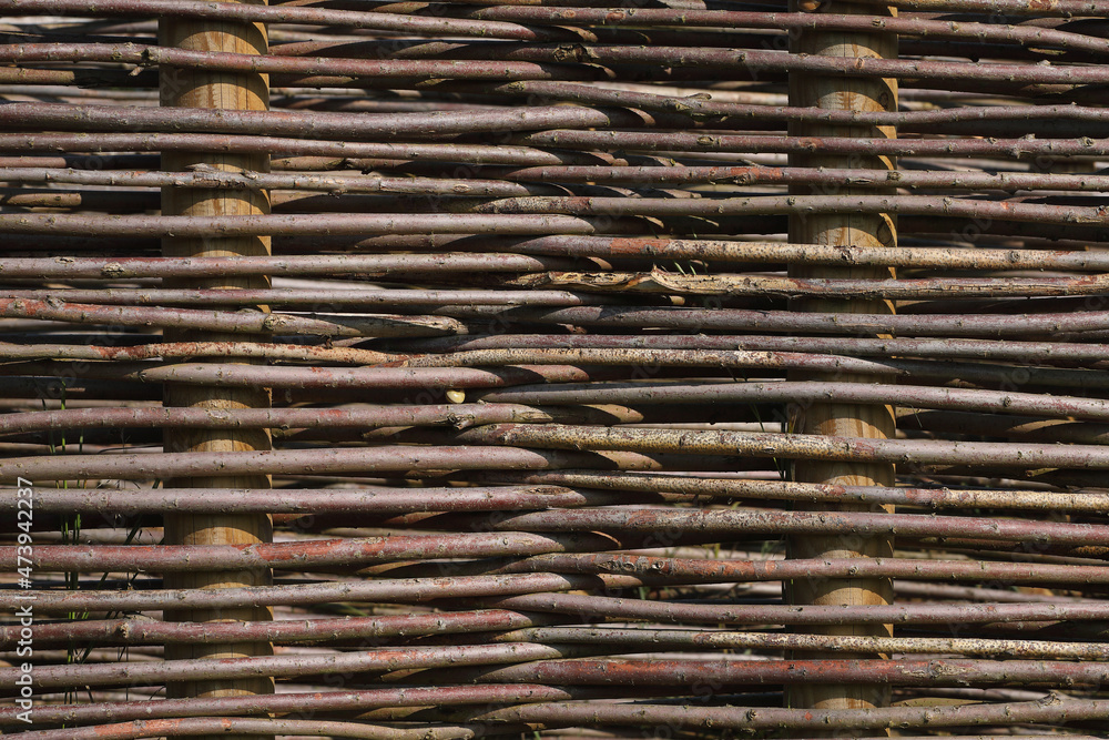 A close-up of a fence made out of branches of a Willow
A close-up of a fence made out of branches of a Willow