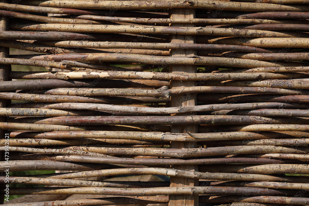 A close-up of a fence made out of branches of a Willow
A close-up of a fence made out of branches of a Willow