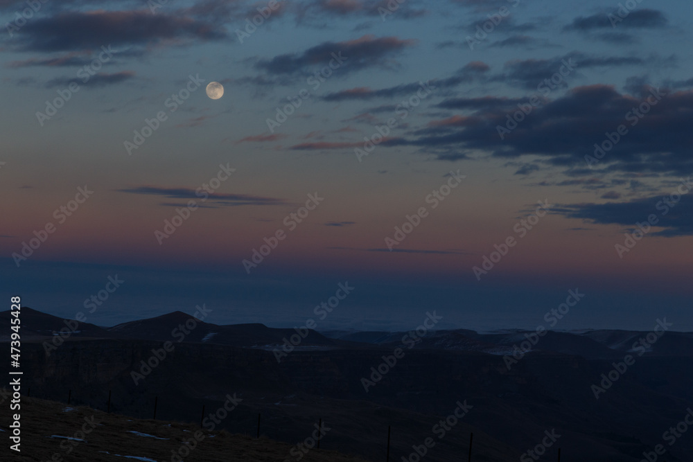 The moon in the setting cloudy winter sky The moon in the setting cloudy winter sky