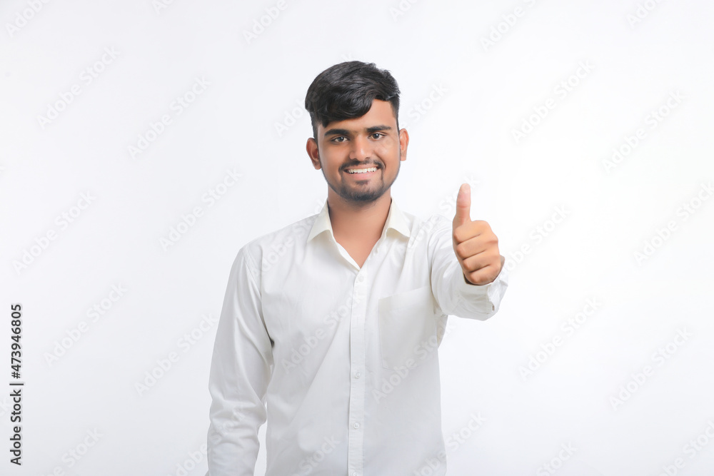 Young indian college student showing thumps up. Young indian college student showing thumps up.