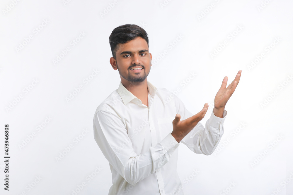 Young indian man giving expression with hand over white background. Young indian man giving expression with hand over white background.