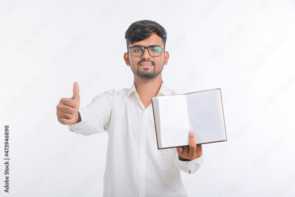 Young indian man showing diary on white background. Young indian man showing diary on white background.