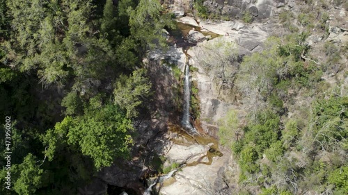Visitors enjoying the crystal clear and warm waters of Fecha de Barjas waterfall, Peneda-Gerês National Park, Portugal photo