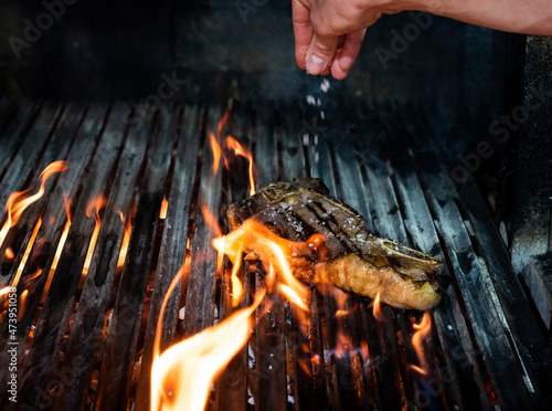 Fotografia, Obraz Beef T-bone steak on the grill with flames