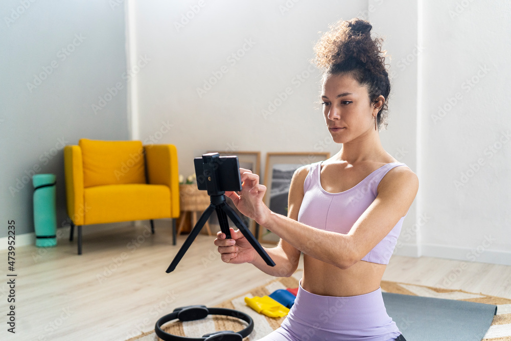 Female vlogger touching mobile phone at home Female vlogger touching mobile phone at home
