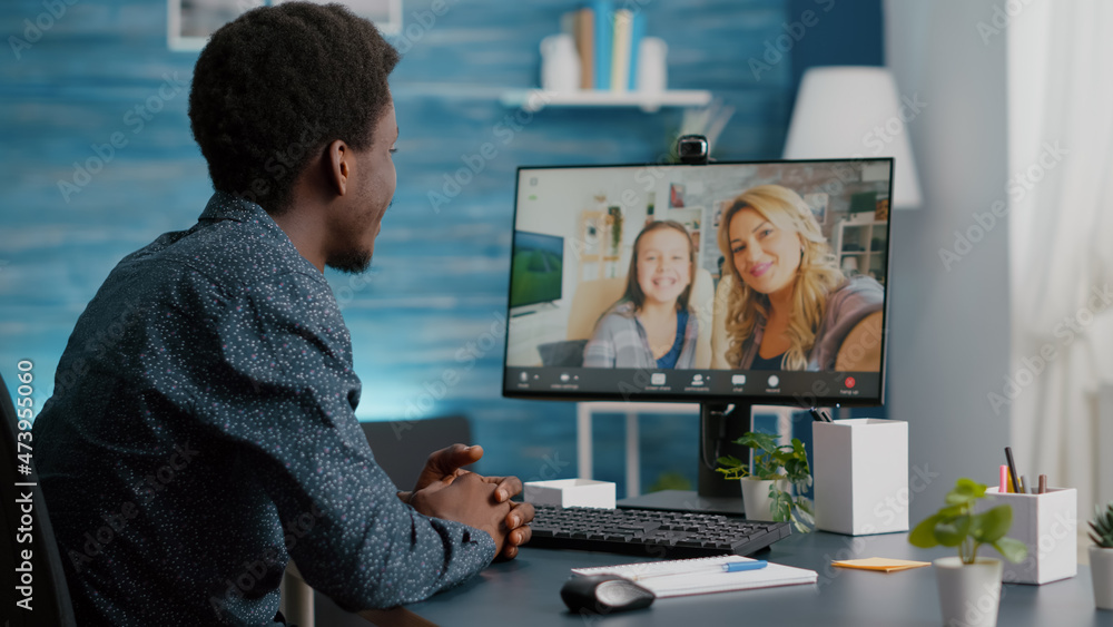 Selective focus on african american man talking with friends and family using online video call communication and webcam. Black man video conference from home office, remote intenet chat conversation Selective focus on african american man talking with friends and family using online video call communication and webcam. Black man video conference from home office, remote intenet chat conversation