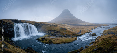 Famous Kirkjufell mountain with cascade waterfalls, Iceland. Kirkjufell is one of the most beautiful natural heritage of Iceland