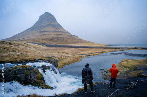 Landscape photographer photographing incredible landscape scenes in Iceland. Kirkjufellsfoss, Iceland. Best famous travel locations