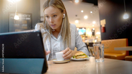 young female businesswoman working with her tablet in lunch pose
